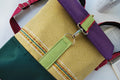 Mochila média textura amarelo claro com bordados,  topo roxo, fundo verde escuro | Joana Candeias
